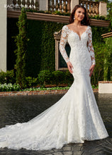 Load image into Gallery viewer, A young woman wear a beautiful mermaid style bridal gown in the color ivory nude.

